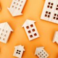 Many miniature wooden houses. Real estate concept. Buying and selling housing. Rent. Mortgage rates. Market Analytics. Demand for housing. Rising and falling home prices. Population