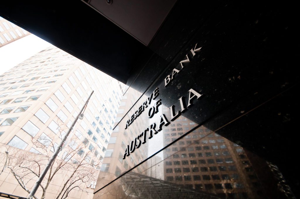 Reserve Bank of Australia name on black granite wall in Melbourne Australia with a reflection of high-rise buildings. 