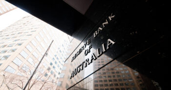 MELBOURNE, AUSTRALIA - JULY 26, 2018: Reserve Bank of Australia name on black granite wall in Melbourne Australia with a reflection of high-rise buildings. The RBA building is located at 60 Collins St, Melbourne VIC 3000 Australia.
