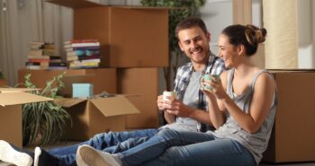 Happy couple moving home resting and talking