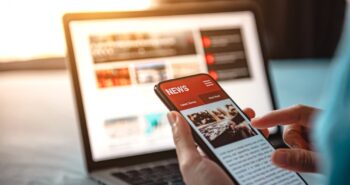Online news on a smartphone. Mockup website. Woman reading news or articles in a mobile phone screen application at home. Newspaper and portal on internet.