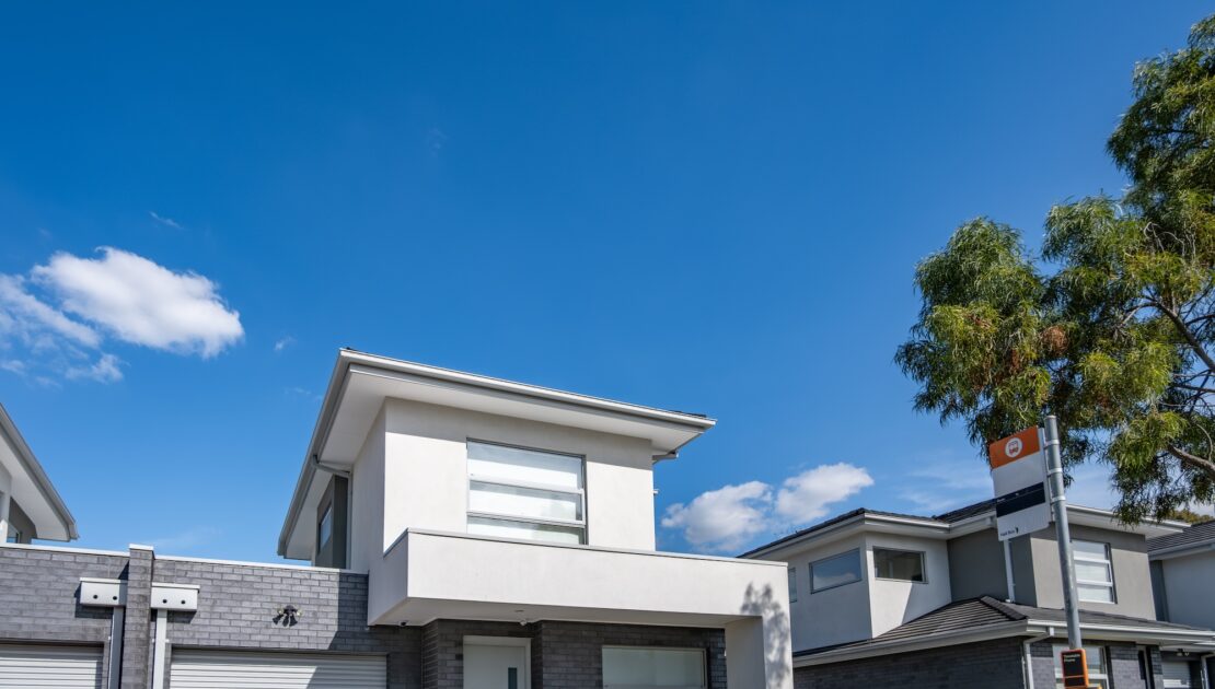 Townhouses with a bus stop out the front.