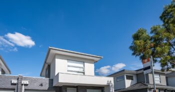 Townhouses with a bus stop out the front.