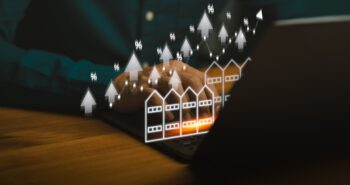 Real estate market growth concept showing person using laptop with rising commercial building icons, percentage symbols, and upward arrows, representing property investment, shophouse, housing trends.