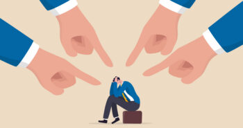 Toxic work, abuse or bullying colleagues, bad culture make exhausted depressed employee, fear of failure and responsibility, giant boss hands pointing and blaming at depressed businessman employee.