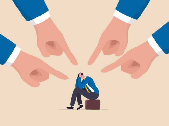 Toxic work, abuse or bullying colleagues, bad culture make exhausted depressed employee, fear of failure and responsibility, giant boss hands pointing and blaming at depressed businessman employee.